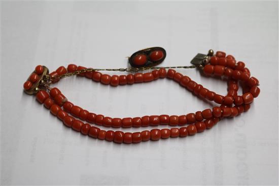 A triple strand coral bead bracelet with French silver mark, a coral and facetted bead necklace and a coral mounted clasp.